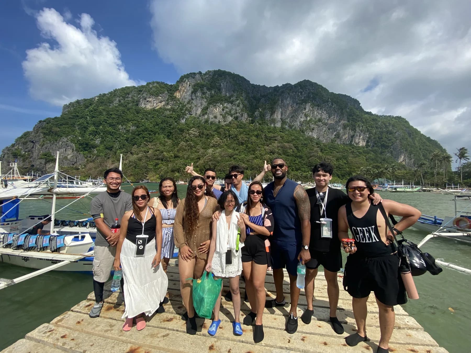 The MyThorneAI team standing on a dock in front of a limestone island
